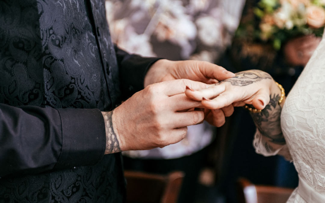 a person putting a ring on a person's hand